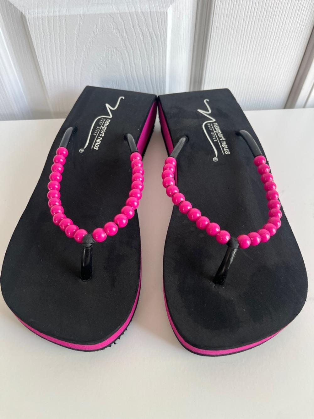 Newport News black platform flip-flops featuring pink beaded straps. Size 8
